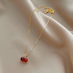 Enhance any outfit with this beautiful Wine Red Cherry Gold Pendant Necklace. Featuring a classic design and bold red hues, it will make a stunning fashion statement that will be admired by all. This statement piece is perfect for your collection. Red Ruby Jewelry Gift For Her, Red Round Jewelry, Trendy Red Pendant Necklace, Trendy Red Jewelry With Adjustable Chain, Red Clavicle Chain Necklace For Party, Elegant Cherry Colored Jewelry For Party, Minimalist Red Jewelry For Party, Cherry Jewelry For Valentine's Day Party, Cherry Color Jewelry For Valentine's Day Party