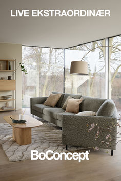 a living room filled with furniture and large windows