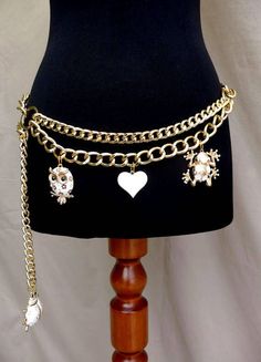 Gold Hand Made Double Swag Hip Chain Belt with an Enamel Owl, Heart, Frog & Ladybug Charms. Drape Shape Chain Belt features two chunky gold coloured curb link with double draping chains divided  by two big gold rings on either side, and adjustable clasp closure. A White and Gold enamel Heart which dangles from the middle the be is flanked on ether side of the chain by  a cute Gold & White enamel Owl (1"5)  Charm and a Gold & White enamel Frog (1"6)  The end of the chain is finished with a fab la Unique Belts, Big Gold Chains, Hip Chain, Skz Concert, Jewelry Belt, Hip Jewelry, Belly Belt, 2024 Jewelry, Dr Wardrobe