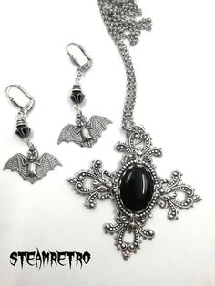 "This fantastic silver plated filigree cross necklace features a Swarovski black jet crystal and is part of our new Dark Gothic range, and is a step away from our previous steampunk work.The set comes complete with our spooky silver plated vampire bat earrings! There are numerous Gothic designers out there, and various marketplaces to purchase Gothic jewellery, but i am sure you will like what we are doing here Growing up in the 80's i lived through the \"goth\" movement, many a lost weekend was Black Vampire Pendant Jewelry, Black Vampire Style Pendant Jewelry, Gothic Metal Cross Necklaces, Halloween Gothic Pendant Jewelry, Gothic Metal Cross Pendant Jewelry, Gothic Cross Pendant Jewelry, Silver Metal Witchy Jewelry, Gothic Metal Necklace, Silver Witchy Metal Jewelry