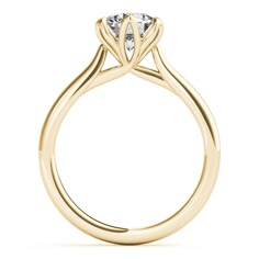 a yellow gold engagement ring with an oval cut diamond in the center and side stones