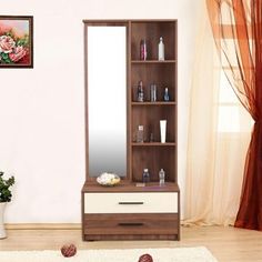 a room with a mirror, shelf and vase on the floor next to a window