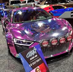 a purple car is on display at an auto show with other cars in the background