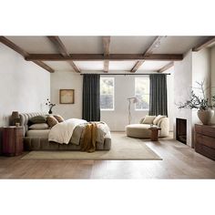 a living room filled with furniture and a large window next to a wooden floor covered in curtains