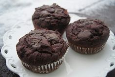 three chocolate muffins on a white plate