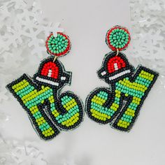 a pair of earrings made out of beads