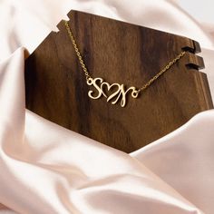 The perfect personalized gift for the favorite woman in your life.  This is a double Initial with an interlocking heart necklace. We can customize our Name Necklaces as you wish. It can be purchased as a Personalized Gift. We can manufacture using up to 2 letters.  No special characters.   The necklace is 17 inch adjustable chain with 3 inch extension chain to fine tune the fit (total length = Chain + Charm) with a sturdy lobster clasp.  All necklaces are packaged in elegant black jewelry box. Details Handmade item Materials: Plated Gold, Plated Rose Gold or Silver Base Metal: 316 stainless steel Closure: Lobster claw Adjustable length Style: Minimalist Can be personalized Made to Order Proudly made in the USA, using American Steel. This Customer Double Initial Necklace is a perfect gift f Black Jewelry Box, Initial Heart Necklace, Custom Initial Necklace, Rose Gold And Silver, 18k Gold Necklace, Custom Name Necklace, Silver Plated Necklace, Black Jewelry, The Favorite