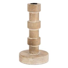 a tall wooden vase sitting on top of a white table