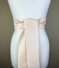 Wide Textured Light  Golden  Champagne Sash Belt  Golden Champagne Dupioni Sash  Champagne Dress Sash  Champagne Wedding  Bridesmaid Sash  Add crisp texture and graceful polish to your special occasion outfit with this Satin Swank® dupioni waist sash. Depending on your waist size and the length you choose, you can wrap this sash around your waist once or twice. You decide whether to tie the sash in a bow or a simple knot with long-hanging tails. Tie in front, in back, or on the side. A double layer of crisp dupioni fabric in a light golden champagne shade. Sash is the same front and back with seams hidden within the fold lines. Dupioni features a rustic weave with naturally occurring slubs running throughout the fabric resulting in exquisite depth, texture, and sheen. SIZING/COLOR/PRINT IN Bridesmaid Sash, Waist Sash, Champagne Dress, Dress Sash, Sash Belts, Special Occasion Outfits, Champagne Wedding, Suspender Belt, Suspenders