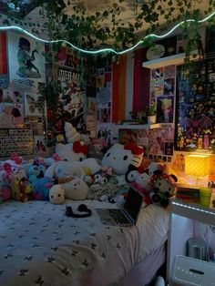 a bedroom with many stuffed animals on the bed