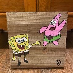 a wooden block with an image of spongebob and patrick on it