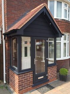 a small brick building with a white door and windows