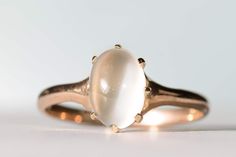 "Lovely antique natural moonstone ring in 10K yellow gold. This lovely ring features a gorgeous 9.5x7.2mm natural moonstone cabochon mounted in a lovely Edwardian yellow gold mount. The moonstone is held in place with eight prongs, all in excellent condition. Ring size 7 3/4 and easily sized up or down several sizes.  Please allow one week for sizing. One month layaway payment plans available for rings $500 and over. Approximate Age - Edwardian Gemstone(s) - natural moonstone  Metal - 10K yellow gold Weight - 2.06 grams Ring size - 7 3/4 Marks - 10K Makers Mark -  Comments -  Service & Sizing Information: If you require ring sizing or service, kindly follow the link below to add the appropriate service fee from the dropdown menu at the time of purchase. Also, please note your desired ring 14k Gold Oval Cabochon Moonstone Ring, Classic Moonstone Cabochon Ring For Anniversary, Antique Oval Cabochon Moonstone Ring, Antique Moonstone Ring, Oval Cabochon, Antique Moonstone Oval Cabochon Ring, Classic 14k Gold Moonstone Ring Oval Cabochon, White Oval Cabochon Moonstone Ring In 14k Gold, White Moonstone Oval Cabochon Ring In 14k Gold, 14k Gold Moonstone Cabochon Ring For Anniversary