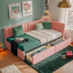 a pink and green daybed with drawers underneath it in a bedroom next to a window