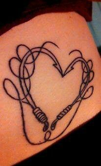 a heart tattoo on the side of a woman's arm with wires in it