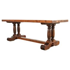 an old wooden table with two legs and one leg on the end, against a white background