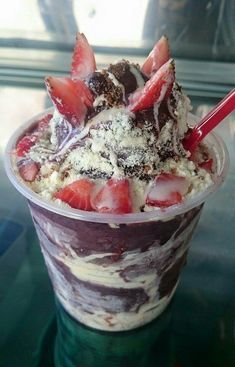 an ice cream sundae with strawberries and chocolate