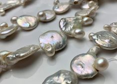 Material : Genuine Freshwater Pearl Quantity : Full Strand- 15.5-16 Inch Shape : Flat Irregular Coin Bead Size: 19 - 21 mm approx. Color : 2 Color Options :- - Natural White ; OR - Natural Seaweed We ship all orders within 24 hours from the U.S. (We closed on Saturday and Sunday) ** We Offer CUSTOM MADE SERVICES and WHOLESALE DISCOUNTS on LARGE QUANTITY PURCHASE. Please convo us on your requirements. We will be happy to create a private listing for you** As the variations in materials, there mig Round Pearl Beads For Jewelry Making, Pearl Beads For Jewelry Making, Pearl Drop Beaded Necklaces With Round Beads, Round Beaded Necklaces With Pearl Drop For Jewelry Making, Pearl Necklace With Large Beads As Gift, Pearl Necklace With Large Beads For Gift, Large Bead Pearl Necklace Gift, Large Beads Pearl Necklace As Gift, Pearl Necklace With Large Round Beads