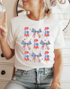 4th of July popsicle shirt, patriotic shirt, Independence Day shirt, American flag, 4th summer shirt, America shirt, USA vintage shirt  My shirts, sweatshirts, and tanks are a fun and joyous way to show your style while shopping, heading to the beach, and bringing your children to social events, family outings, and everyday life. All my t-shirt designs are direct to garment and provide the best quality and longevity.  Vintage Strawberry Floral Picture:  Cottage core floral design Sizes: S - 2XL Fun Cotton Shirt For Independence Day, Fun Independence Day Cotton Shirt, Patriotic Flag Print Shirt For 4th Of July, Patriotic American Flag Print Short Sleeve Top, Patriotic Shirt With Flag Print For 4th Of July, Summer American Style Shirt With American Flag, Spring American Flag Short Sleeve T-shirt, American Flag Print Shirt For Memorial Day, Patriotic Shirt With American Flag Print For Independence Day