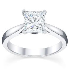 a princess cut diamond engagement ring on a white background, with the band around it