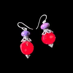 Elevate your style with these stunning earrings featuring purple turquoise and red coral stones accented with intricate Bali-inspired embellishments. These earrings hang elegantly at 1 inch, adding a touch of exotic charm to any outfit. Red Sterling Silver Nickel-free Beaded Earrings, Nickel-free Red Beaded Sterling Silver Earrings, Red Sterling Silver Earrings With Natural Stones, Vibrant Dangle Earrings With Ear Wire, Unique Red Flower Earrings, Red Earrings With Natural Stones In Round Beads, Handmade Red Coral Dangle Jewelry, Vibrant Drop Earrings Jewelry Gift, Vibrant Drop Earrings For Gifts