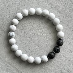 Men's beaded bracelet features: Matte White Howlite Black Lava ~ 6mm or 8mm black lava beads Matte White Howlite Black Lava ~ 6mm or 8mm matte white howlite beads Matte White Howlite Black Lava ~ 4mm or 6mm hematite round spacers Matte White Howlite Black Lava ~ Stretchy cord; simply slide bracelet on and off wrist Matte White Howlite Black Lava ~ Comes packaged in a re-usable microfiber pouch To ensure the perfect fit, please use the bracelet sizing instructions found in the photo gallery. Black And White Beaded Bracelet, Bracelet Man, Lava Bead Bracelet, Slide Bracelet, White Bracelet, Lava Beads, White Bracelets, White Howlite, Gemstone Beaded Bracelets