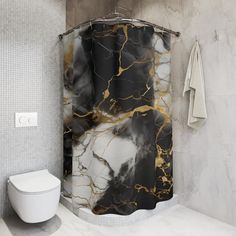 a white toilet sitting next to a black and gold shower curtain