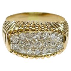 18 Karat Two-Tone White and Yellow Gold Diamond Pavé Ring. The ring features nineteen round pave brilliant-cut diamonds set in white gold. There are seventeen 2.0mm diamonds with a carat weight 0.51ctw, and two 2.5mm diamonds with a carat weight of 0.10ctw. The diamonds have a total carat weight of 0.61ctw. The yellow gold band has ridges along the top and bottom where the diamonds are set in the middle and to about half way of the band. Stamped on the inside of the band is 750 18K. The ring siz Luxury Cluster Diamond Ring With Single Cut Diamonds, Classic Platinum Cluster Ring With Pave Setting, Luxury Diamond Signet Ring With Round Cut, Luxury Diamond Cluster Ring With Pave Setting, Formal Diamond Cluster Ring With Pavé Setting, Luxury Cluster Diamond Ring With Accents, Formal Cubic Zirconia Signet Ring With Pave Setting, Platinum Signet Ring In Diamond White With Brilliant Cut, Classic Diamond White Cluster Ring With Pave Setting