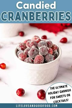 a white bowl filled with cranberries and covered in powdered sugar on top of a table