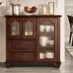 a wooden cabinet with glass doors in a living room