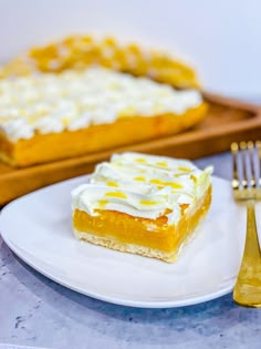 a piece of cake sitting on top of a white plate next to a knife and fork