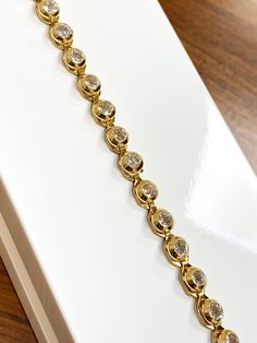 Add an extra element of elegance to your look with our beautiful Bezel Cubic Zirconia Set Tennis Bracelet. This bracelet will be sure to sparkle with every move. 🔹 Sale Price - £460.00 🔹 Length - 7 Inch  🔹 Stone - Cubic Zirconia  🔹 Metal - 9ct Yellow Gold  🔹 Weight - 8.5 Grams Yellow Gold Bracelet With Bezel Setting Cubic Zirconia, Yellow Gold Cubic Zirconia Bracelet With Bezel Setting, Wedding Gold Bracelet With Diamond Bezel Setting, Gold Diamond Bracelet With Bezel Setting For Wedding, Wedding Diamond Gold Bracelet With Bezel Setting, Wedding Diamond Bracelet With Bezel Setting, Wedding Gold Diamond Bracelet With Bezel Setting, Gold Bracelet With Bezel Setting For Formal Events, Dazzling Gold Bracelet With Cubic Zirconia