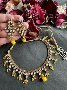 This traditional Kundan gold finish necklace set, featuring intricate yellow accents, is a stunning piece of Indian jewelry. Perfect for party wear or Bollywood-inspired events, it exudes elegance and a touch of glamour. The craftsmanship of Kundan work adds a timeless charm, making it an ideal choice for special occasions. Gold Chandbali Jewelry Sets For Parties, Traditional Gold Jewelry For Party, Festive Gold Jewelry Sets, Gold Chandbali Kundan Necklace As Gift, Party Kundan Necklace With Gold Beads, Gold Kundan Necklace As A Gift, Gold Jewelry Sets For Festive Occasions, Gold Necklaces For Party Festivals, Festive Kundan Gold Necklaces