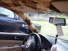 the interior of a car with a steering wheel and dash camera attached to the dash board