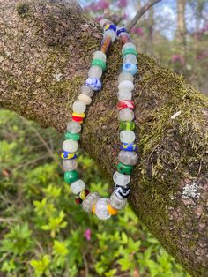 This 17.25 inch necklace is made with lampwork beads in the Norse style. The beads are made of COE 104 glass and the patterns on the beads are based on beads from the Norse and Anglo Saxon world. The glow beads are made with glow powder and give off a green, aqua, or blue glow when charged with light. The piece is strung on stainless steel wire and finished with stainless steel findings and a stainless steel lobster claw clasp. Many of the beads are made of COE 104 soft glass.  Green glows the b Multicolor Recycled Glass Beads For Jewelry Making, Multicolor Recycled Glass Jewelry For Jewelry Making, Recycled Glass Beaded Necklaces As Gifts, Recycled Glass Beaded Necklaces For Gifts, Recycled Glass Beaded Necklaces With Round Beads As Gift, Recycled Glass Beaded Necklace With Round Beads As Gift, Artisan Adjustable Glass Beads, Multicolor Recycled Glass Jewelry With Large Beads, Multicolor Recycled Glass Beaded Jewelry