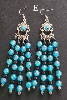 These earrings are made from a variety of glass, metal, and plastic seed beads in an old fashioned style resembling medieval, renaissance, or viking jewelry. They are suitable for ethnic or traditional outfits, LARP accessories, or Renaissance style clothing, or even just because you want something a bit unusual and unique. Length : 11 cm Width: 3 cm Nickel free. Due to variations in screens, cameras, and lighting conditions, the colors in the beads are generally much brighter in person, especially under sunlight. Translucent beads included in designs tend to sparkle, which is difficult to convey in a photo. For any questions, please feel free to contact me! Handmade Bohemian Dangle Clip-on Earrings, Handmade Retro Silver Earrings, Vintage Beaded Drop Earrings For Festivals, Vintage Dangle Beaded Earrings For Festival, Retro Dangle Earrings For Festivals, Vintage Blue Earrings For Festival, Handmade Retro Dangle Jewelry, Vintage Multicolor Czech Glass Earrings, Retro Handmade Dangle Jewelry