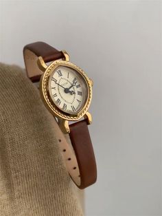 Welcome to AffordLuxe Watches! We're delighted to have you here in our store 🤩 Elevate your style with this elegant timepiece featuring a rich brown leather band and a sophisticated gold-tone case. The classic Roman numeral dial adds a touch of vintage charm, while the intricate bezel detailing enhances its luxurious appeal.  ★Material: - Genuine Leather - Stainless Steel  - Glass ★Dimensions: - Case Height: 8mm - Case Length: 25mm - Band Width: 8mm ★Packaging: All watches come in an elegant gift box with a gift bag. ★Care Instructions: - Avoid wearing the watch in the shower or frequently exposing it to hot water. - Substances like oil, nail polish, nail polish remover, chlorine, and perfume may react with metal and cause tarnishing. - Remove the watch when exercising, doing heavy work, Watch Minimalist, Gold Plated Watch, Vintage Watches Women, Oval Face, Watches For Women, Leather Strap Watch, Hozier, Classy Jewelry, Jewelry Lookbook