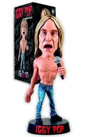 a bobble head figure holding a microphone in front of a box with the words iggy pop on it