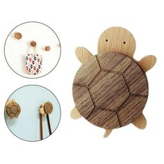 the wooden turtle is next to two different items on display, including chopsticks and an earring