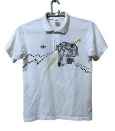 a white t - shirt with an image of a man riding a bike on it