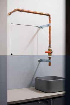 a sink and faucet in a bathroom with white walls, grey countertop