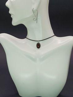 "This exquisite pendant featuring carnelian set in sterling silver indeed embodies both elegance and a vibrant energy. Carnelian, known for its deep, rich hues ranging from orange to reddish-brown, has been cherished through the ages, not only for its beauty but also for its supposed healing properties and ability to inspire courage and creativity. The choice of sterling silver for the frame enhances the warm glow of the carnelian, creating a striking contrast that highlights the stone's natural beauty. This piece of jewelry goes beyond mere adornment; it serves as a talisman of positivity and style. Its timeless design ensures it will be a cherished part of any collection, appealing to those who appreciate the deeper meaning and history behind their accessories.  Note: Keep in mind that t Amber Large Pendant Necklace For Formal Occasions, Amber Necklace With Large Pendant For Formal Occasions, Formal Amber Necklace With Large Pendant, Amber Teardrop Cabochon Necklace, Brown Sterling Silver Round Pendant Necklace, Sterling Silver Brown Round Pendant Necklace, Formal Amber Round Pendant Necklace, Spiritual Amber Cabochon Necklace, Spiritual Amber Necklace With Smooth Stone