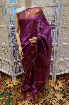 A High Quality Beautiful Magenta Color Handloom Pure Dupion Silk Banarasi Saree with Antique gold Zari Jaal Brocade all over. The entire saree has delicate Gold zari work. It has a gold Zari border and heavy brocade Pallu. A classic traditional Banarasi saree for all wedding celebrations. The saree comes with unstitch attached blouse. In comparison to other silk fabrics, dupion silk fabric is a bit strong because of its dual thread nature. In addition to being the most durable natural fabric, du Handloom Tissue Silk Lehenga With Traditional Drape, Wedding Saree In Tussar Silk With Meenakari, Festive Purple Traditional Wear, Festive Traditional Purple Wear, Purple Raw Silk Traditional Wear With Zari Work, Traditional Raw Silk Blouse Piece With Meenakari, Wedding Banarasi Silk Lehenga With Handloom Details, Festive Purple Raw Silk Traditional Wear, Chanderi Saree With Meenakari For Wedding