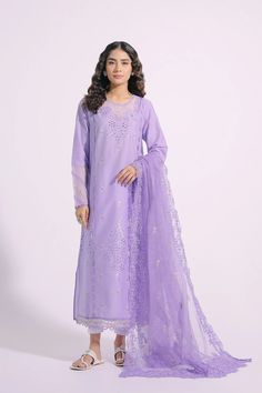 An aesthetically appealing composition is portrayed on this graceful outfit rendered in an appealing lilac shade. It features a classy silhouette shirt beautifully adorned with intricate embroidery at front and sleeves illustrating captivating floral designs with schiffli technique. Paired with a gracefully draped embroidered dupatta with scalloped borders, this gorgeous outfit is a style statement for formal gatherings this season. -Lilac Color -Fabric: Lawn Shirt & Nylon Stripe Dupatta -2 piece Elegant Purple Georgette Dress, Purple Georgette Dress For Formal Occasions, Purple Georgette Formal Dress, Designer Embroidered Purple Lawn Suit, Formal Organza Embroidered Dress With Resham Embroidery, Formal Embroidered Organza Dress, Formal Embroidered Organza Dress For Eid, Formal Embroidered Purple Sets, Formal Organza Dress With Resham Embroidery