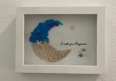 there is a shadow frame with sand and shells in it that says i wish you a happy birthday