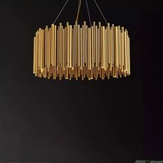 a chandelier made out of wooden sticks hanging from the ceiling in a dark room