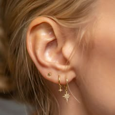 14K Gold huggie hoop earrings with a small Pavé Star Flare accent that hug your ear perfectly. Perfect to create your celestial ear stack 14K Gold Pavé Cubic Zirconia crystal Hypoallergenic, lead and nickel free Inside Diameters: 8mm Star Flare Accent: 4.5mm Click close mechanism #ES185 Ear Piercings Small Hoop, Earrings Aesthetic One Piercing, Gold Earrings Inspiration, Feminine Piercings Ears, Earrings Inspiration Gold, Gold Double Lobe Piercing, Third Whole Ear Piercing, Gold Earring Layout, Hoop With Charm Earrings