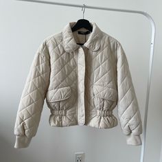 A Great Quality Puffer Jacket. New, Never Worn. Fits S-M If You Have Any Questions, Feel Free To Ask. Trendy Quilted Beige Outerwear, Trendy Beige Quilted Outerwear, Spring Outerwear With Padded Collar, White Quilted Jacket For Spring, Spring Collared Outerwear With Padded Collar, White Cotton Quilted Jacket For Fall, Beige Puffer Jacket With Padded Collar, Beige Long-sleeved Puffer Jacket With Padded Collar, Casual Long Sleeve Quilted Jacket In Winter White