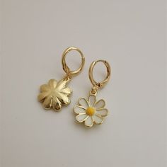 Something for a romantic and gentle soul. Check out these stylish earrings- a perfect little accessory to add some class to your outfit yet remain subtle and minimalist. For a really put together, trendy look. Material: Metal. Trendy Hoop Earrings With Flower Charm For Spring, Dainty Hoop Earrings With Flower Charm, Trendy Gold Hoop Earrings With Flower Charm, Delicate Flower Charm Hoop Earrings, Spring Hoop Earrings With Flower Charm, Trendy Gold Flower Hoop Earrings, Trendy Flower Hoop Earrings, Dainty Flower Shaped Earrings For Spring, Dainty Flower-shaped Earrings For Spring