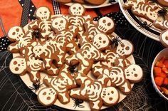 a table topped with lots of halloween cookies